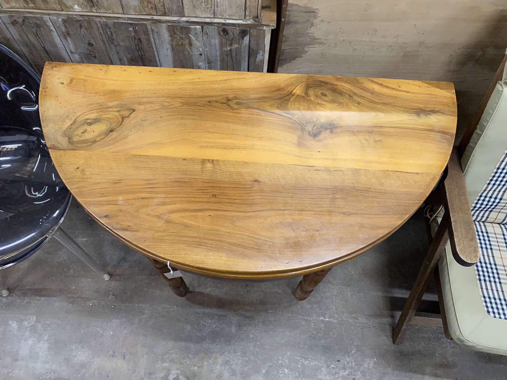 A 19th century French cherry 'D' shaped folding tea table, width 111cm, depth 55cm, height 79cm